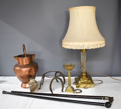 Lot 251 - A glass and gilt metal table lamp, in the form...