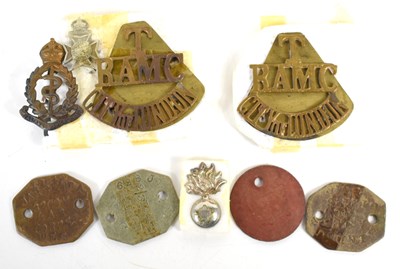 Lot 34 - A group of identity tags and cap badges,...