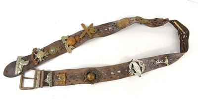 Lot 38 - A vintage leather belt adorned with various...