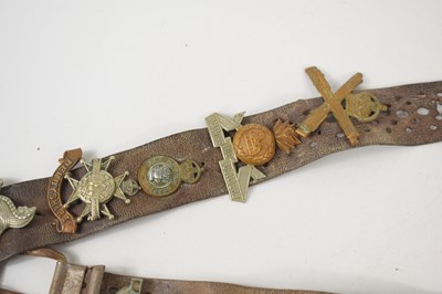 Lot 38 - A vintage leather belt adorned with various...