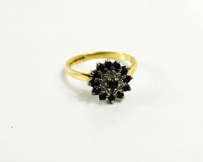 Lot 108 - An 18ct gold cluster ring, set with small dark...