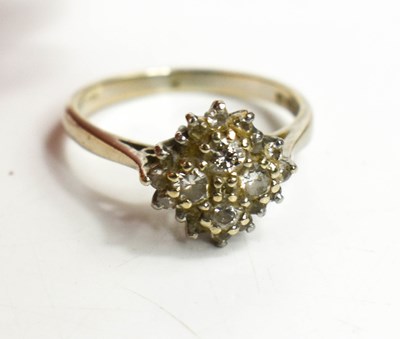 Lot 140 - An 18ct gold and diamond cluster ring, set...