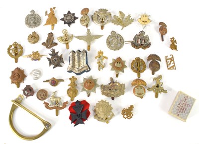 Lot 55 - A group of military cap badges including The...