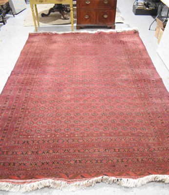 Lot 458 - A large deep red rug, possibly Bokhara, the...