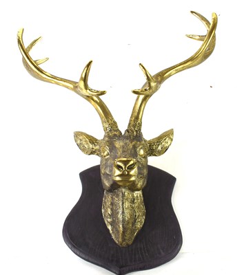 Lot 408 - A wall mounted stags head in a gold coloured...