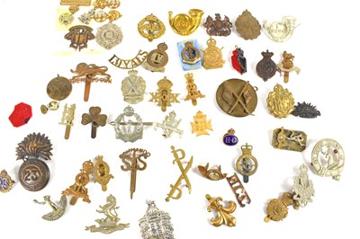 Lot 56 - A group of military cap badges including Army...