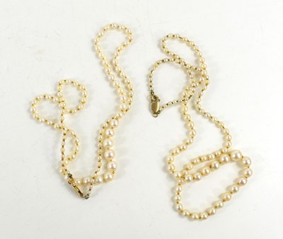 Lot 226 - Two graduated single strand pearl necklaces...