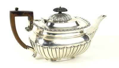 Lot 414 - A silver teapot with gadrooned belly and...