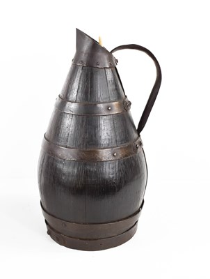 Lot 54 - An 18th century bog oak coopered pitcher,...