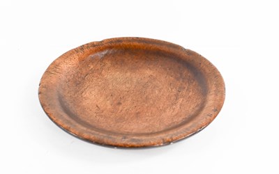 Lot 66 - A 17th century elm platter, 22cm diameter.