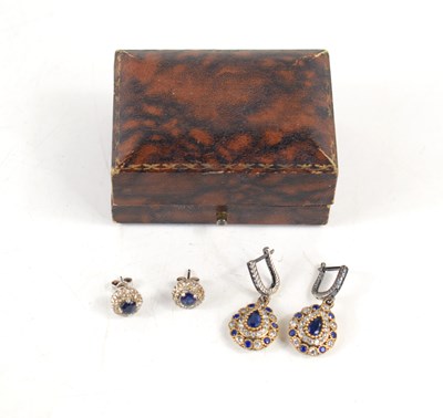 Lot 223 - A pair of sapphire and diamond earrings, each...