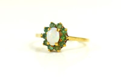 Lot 64 - A 9ct gold, opal and emerald ring, of...