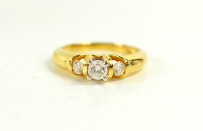 Lot 143 - An 18ct gold and diamond three stone ring, the...