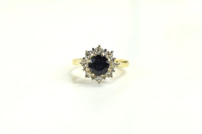 Lot 135 - An 18ct gold, sapphire and diamond flowerhead...