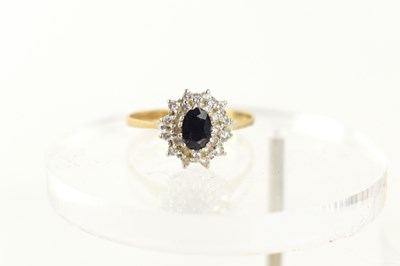 Lot 96 - A 9ct gold, sapphire and diamond cluster ring,...