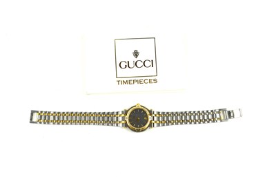 Lot 319 - A lady's Gucci wristwatch, the signed black...