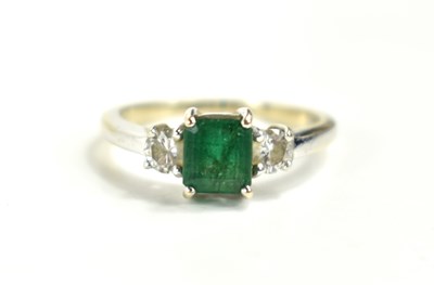 Lot 152 - An 18ct white gold emerald and diamond, three...