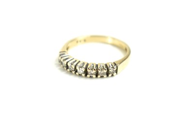 Lot 122 - A 9ct gold and diamond seven stone ring, size...