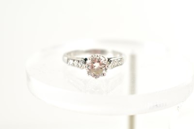Lot 11 - A platinum and diamond solitaire ring, the...