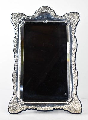 Lot 397 - A silver table mirror, the silver embossed...