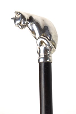 Lot 243 - A walking cane with a silver handle modelled...