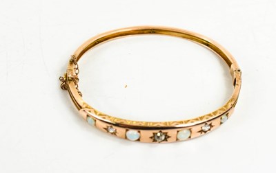 Lot 8 - A Victorian gold, opal and diamond bangle, set...