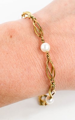 Lot 19 - A 9ct gold and pearl bracelet, composed of...