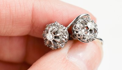Lot 26 - A pair of 9ct gold and diamond flowerhead...