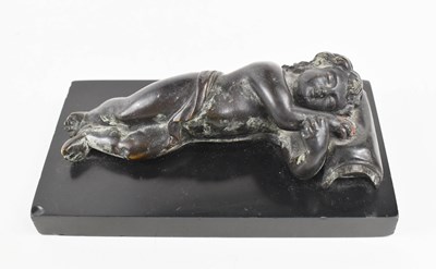 Lot 50 - A small bronze of a sleeping child, his head...