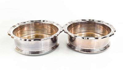 Lot 384 - A pair of silver wine coasters with turned...