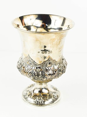 Lot 411 - A silver urn form vase, embossed with flower...