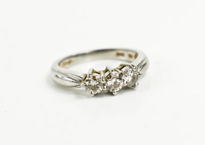 Lot 145 - A platinum and diamond three stone ring, the...