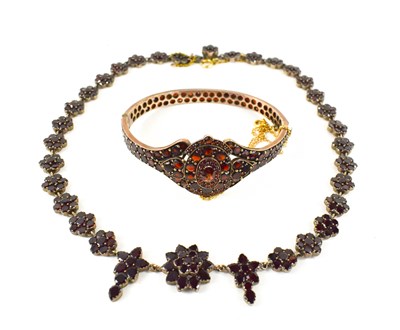 Lot 256 - A 19th century gilt metal and garnet bangle...