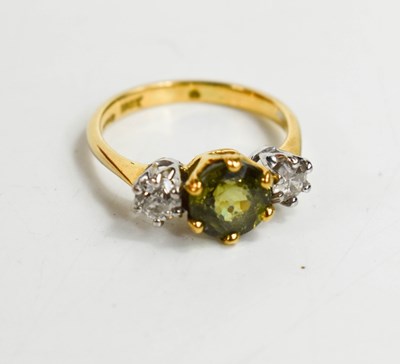 Lot 162 - An 18ct gold three stone ring, set with...