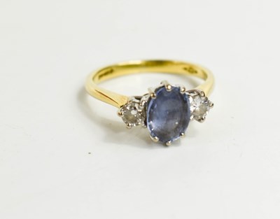 Lot 150 - An 18ct gold, diamond and pale sapphire three...