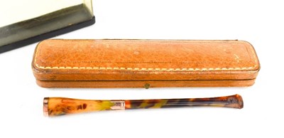 Lot 263 - A vintage cigarette holder, of faux...