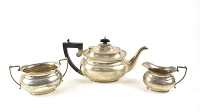 Lot 417 - A silver three piece tea set, the teapot...