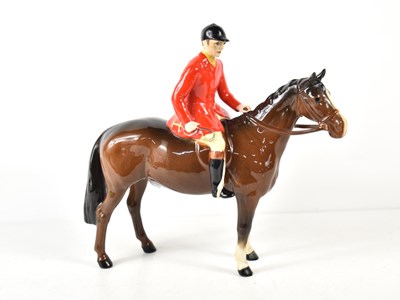 Lot 143 - A Beswick huntsman on standing bay horse,...