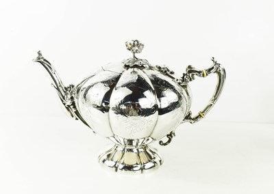 Lot 104 - A 19th century white metal tea pot, of peach...