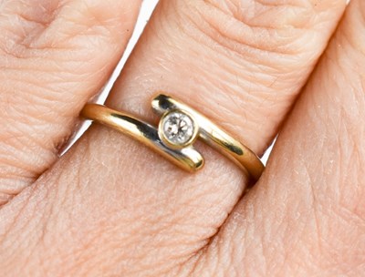 Lot 82 - An 18ct gold and diamond ring, the bezel set...