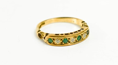Lot 71 - A 9ct gold emerald and diamond seven stone...