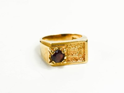 Lot 111 - A gentleman's 9ct gold and garnet set ring of...