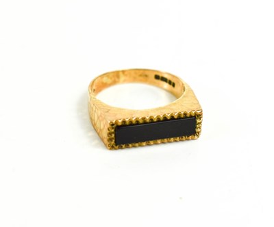Lot 74 - A 9ct gold and jet ring with textured finish,...
