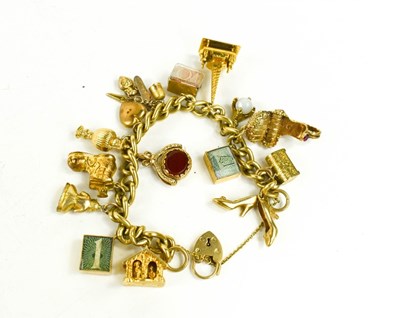 Lot 170 - A 9ct gold curb link charm bracelet, with...