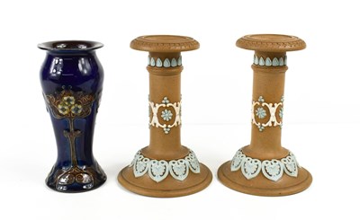 Lot 144 - A pair of Doulton Lambeth candlesticks, by...