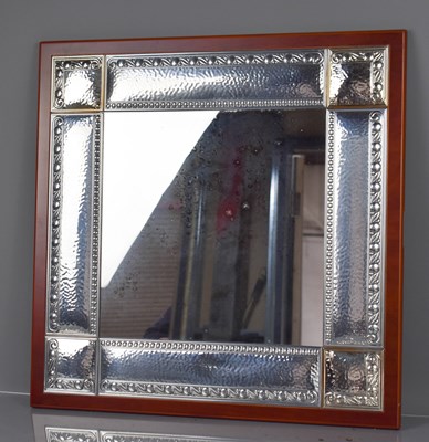 Lot 64 - A white metal Italian mirror, with hammered...