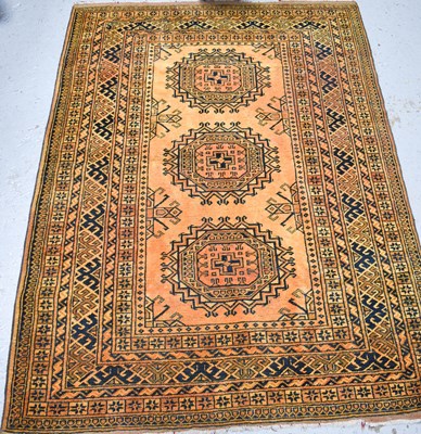 Lot 496 - A wool rug, the ochre ground with black, olive...