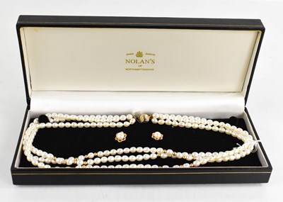 Lot 181 - A 9ct gold and pearl triple strung necklace,...