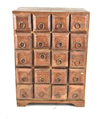 Lot 516 - A teak table-top chest of twenty drawers, each...