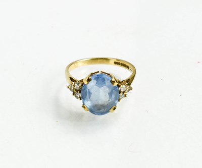 Lot 40 - A 9ct gold, blue topaz and diamond ring, the...